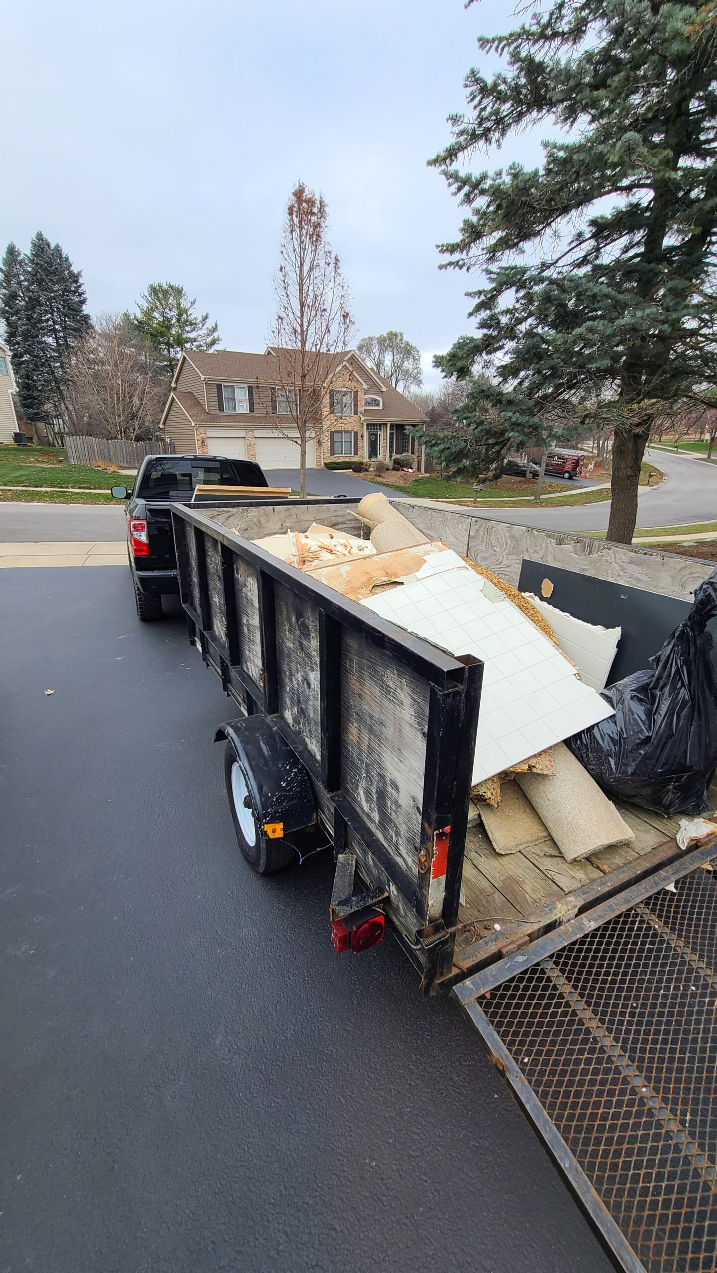 On a job for junk removal with a fully loaded trailer ready to go